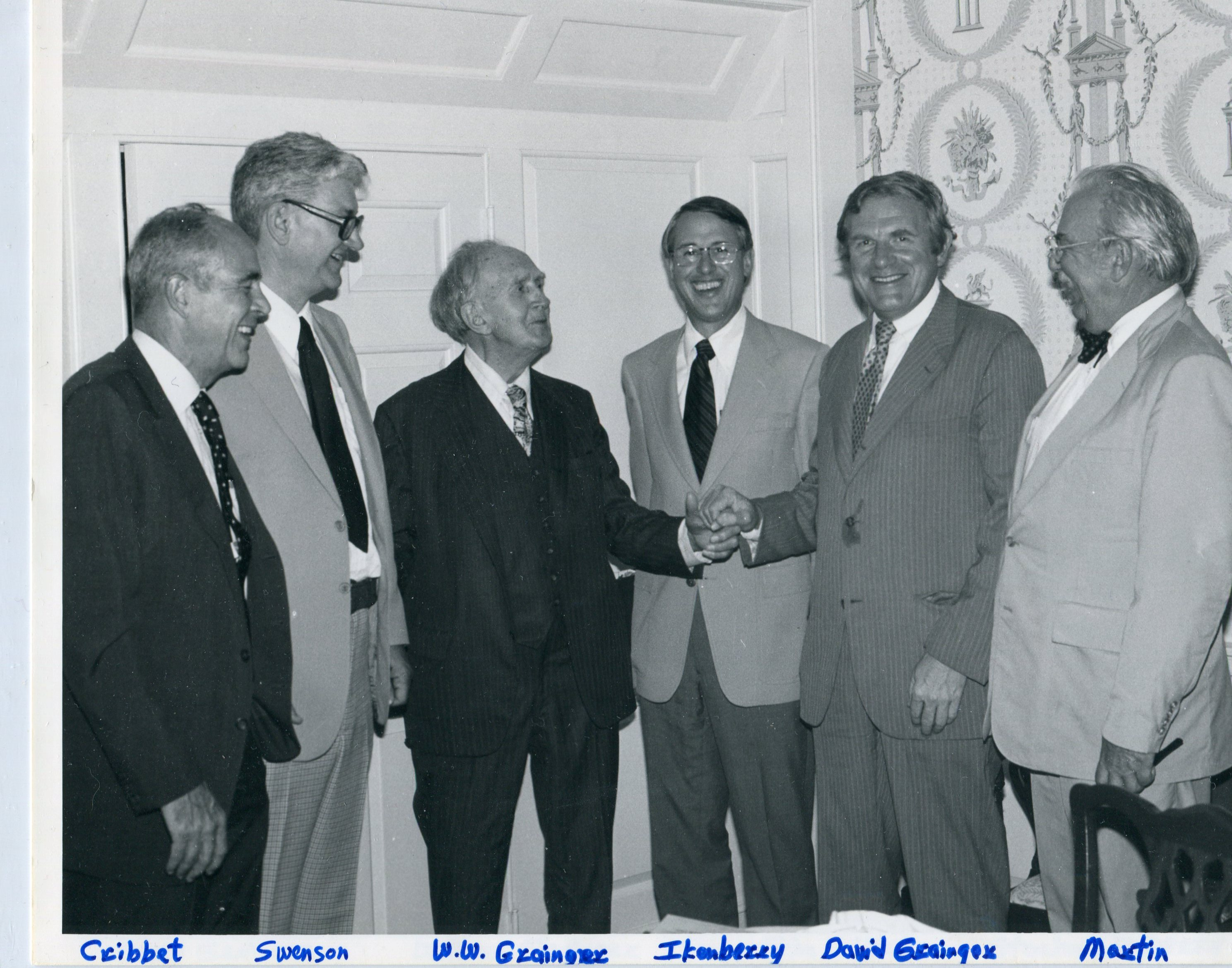 Group photo with W.W. Grainger, third from left, grips hands with son, David Grainger, as they are pictured with, from left, John Cribbet, George Swenson, Stan Ikenberry, and James Cullen Martin in this undated photo.