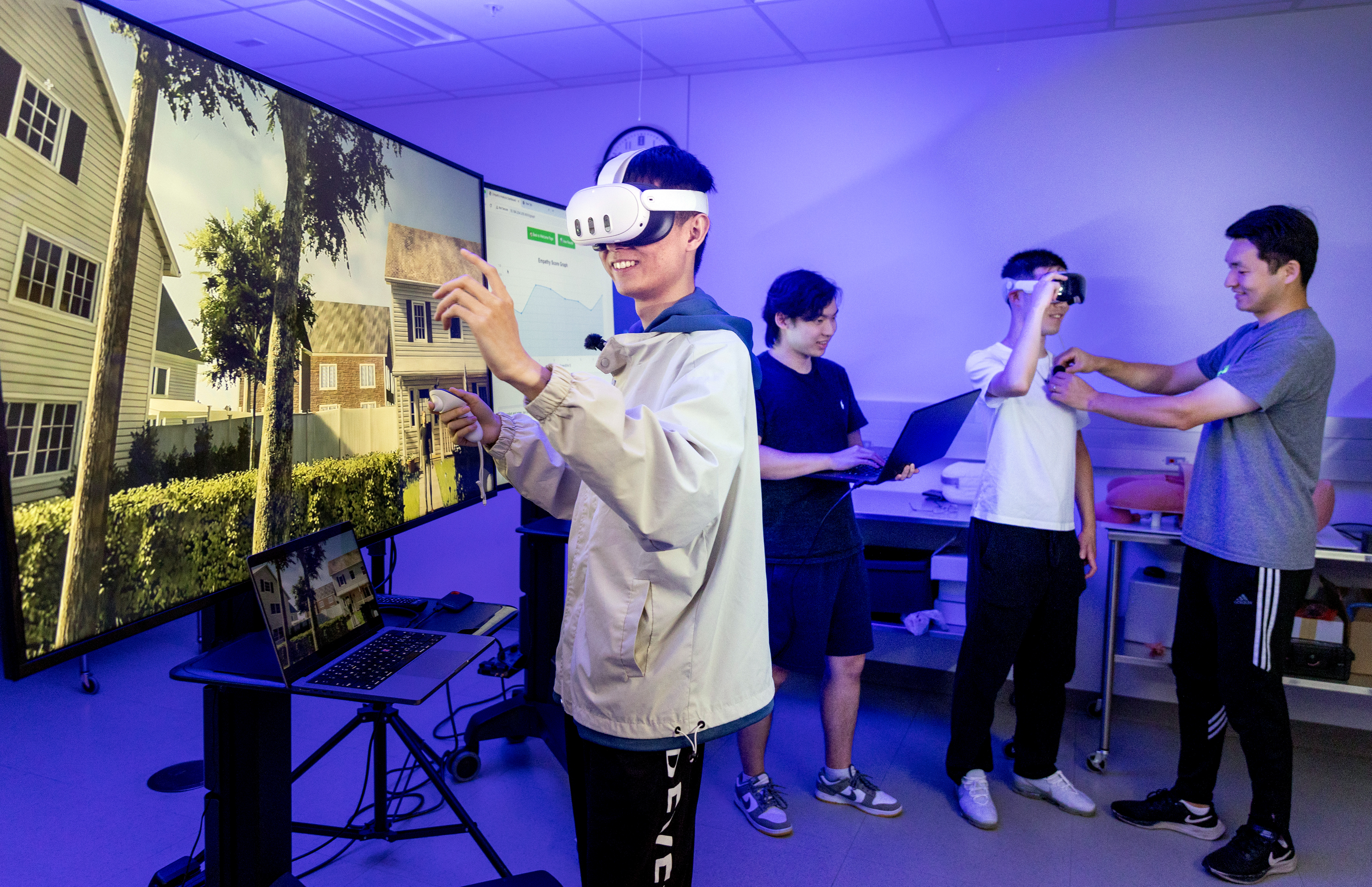 Kyrian Liang (undergraduate) foreground left, uses a VR application for empathy in engineering training as he is joined by, from left, Jackson Song (undergraduate), Tian Sun (graduate) and Duo Wang (graduate) at the JUMP Simulation Center at Everitt Lab on Aug. 4, 2025.