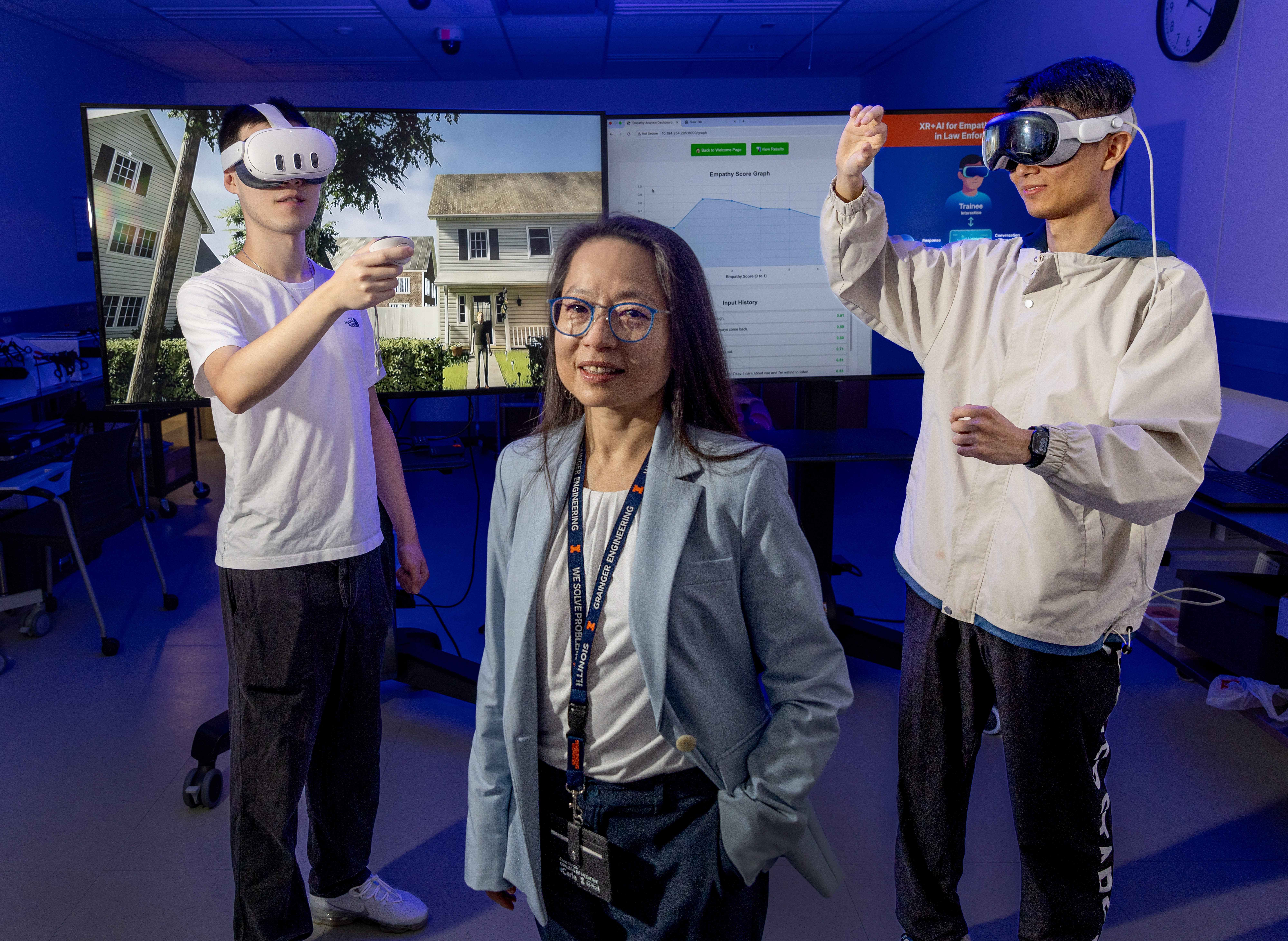 Caroline Cao, center, Industrial and Enterprise Systems Engineering professor, poses with graduate students Tian Sun , left, and Kyrian Liang at the JUMP Simulation Center.