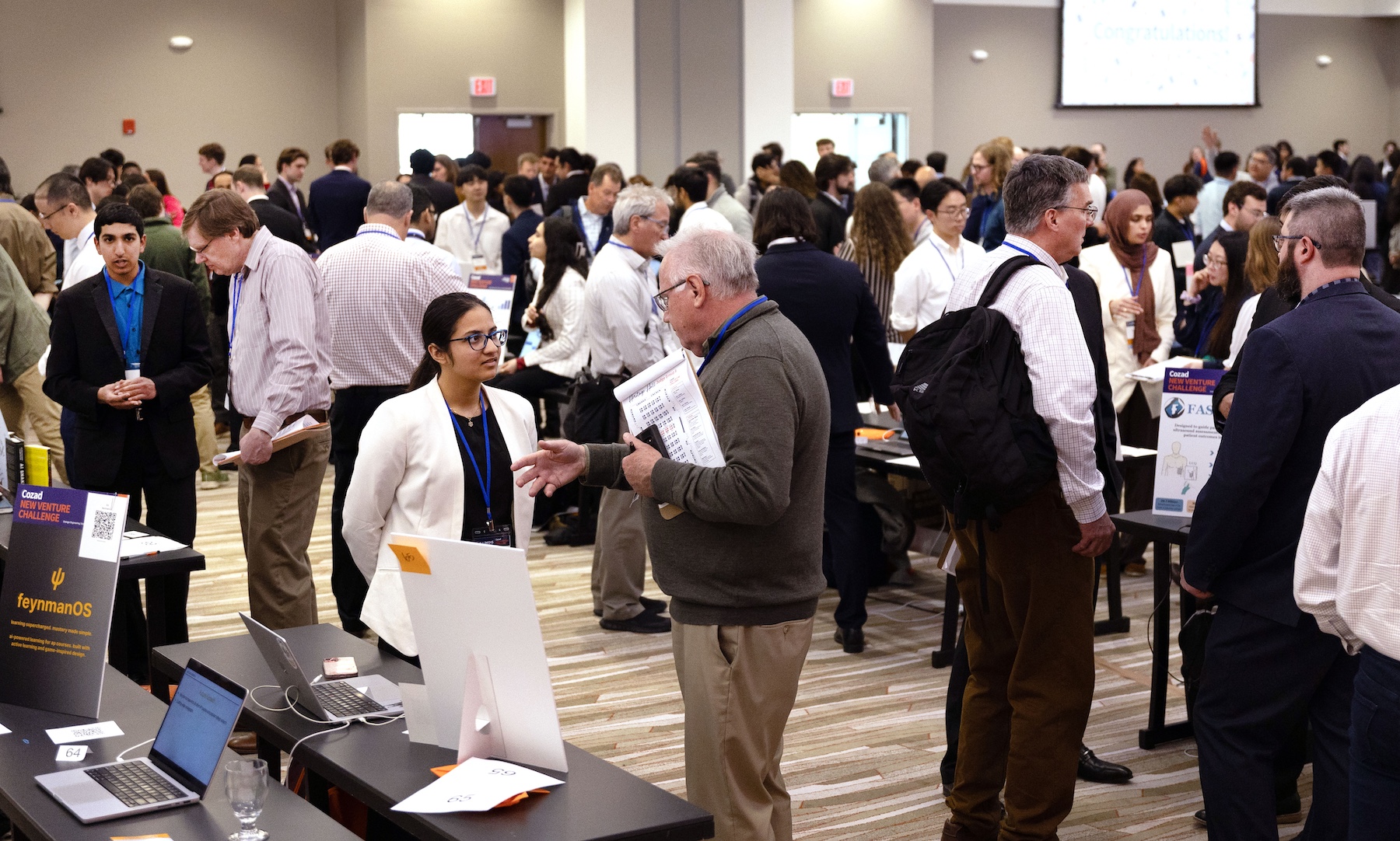 Large crowd of student start-up teams showcasing their ideas in tradeshow environment