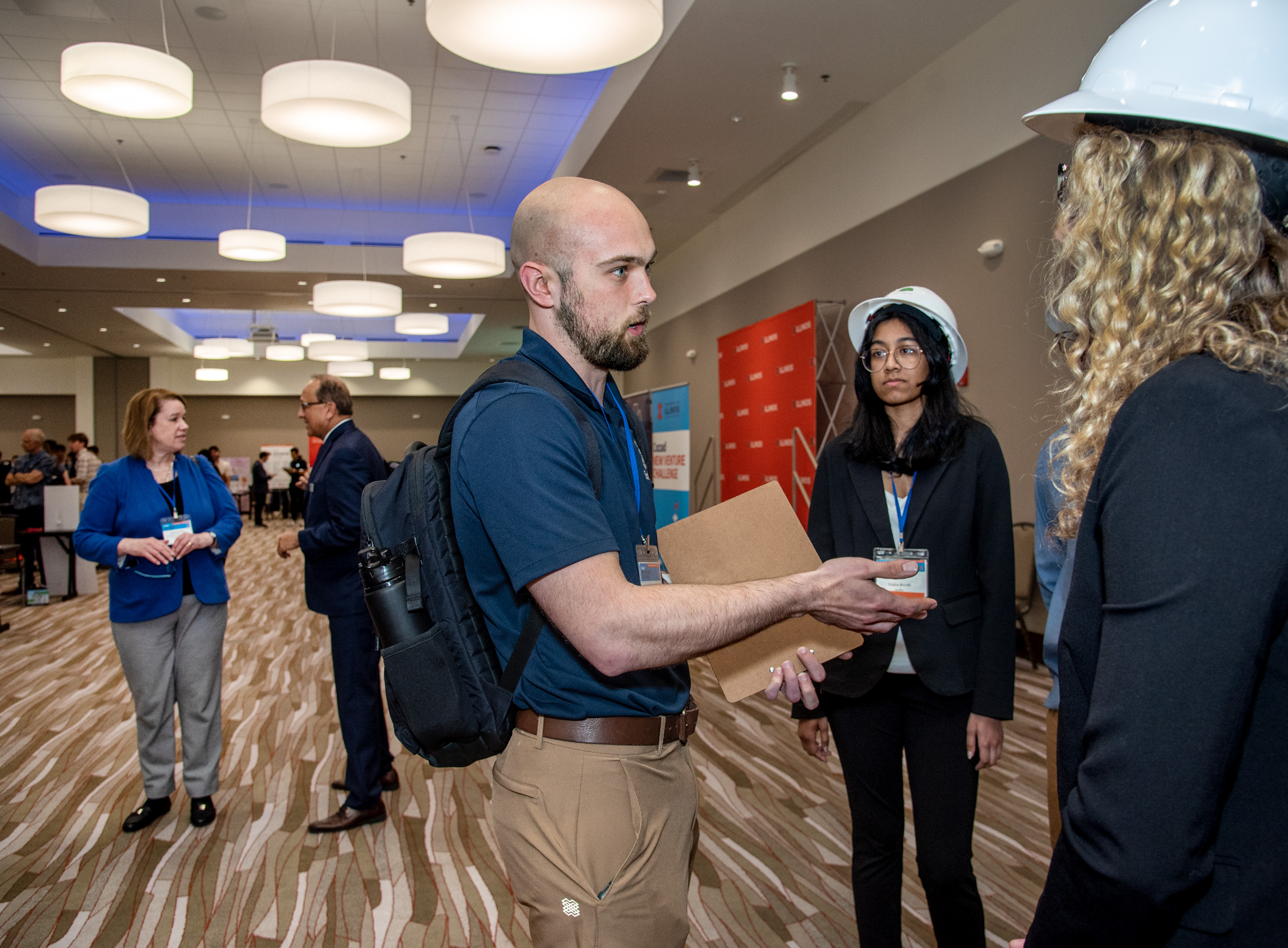 Brandon Yates, center, of DeepWalk, judges.
Over 90 teams made up of young entrepreneurs bring cutting-edge technology to the Cozad New Venture Challenge's Demo Day at I-Hotel and Conference Center in Champaign on April 13, 2023.
