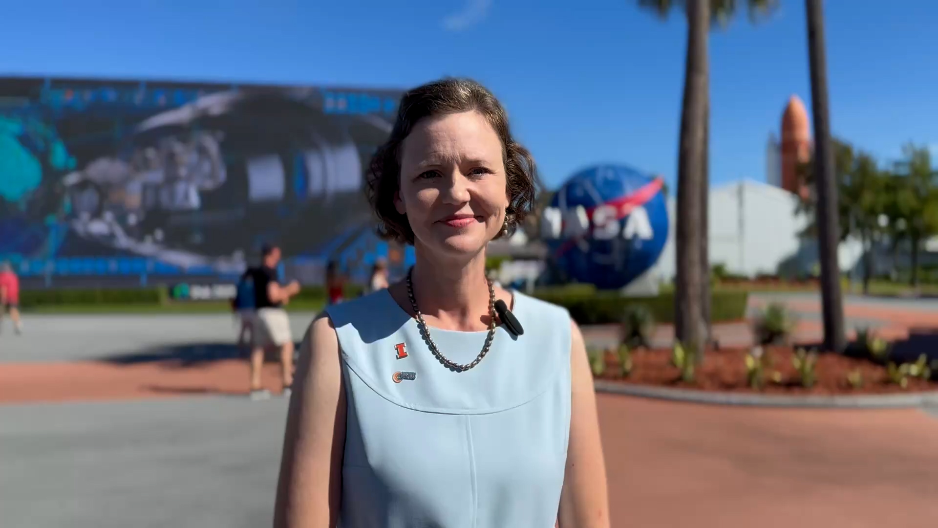 Lara Waldrop, electrical and computer engineering associate professor and Y.T. Lo Fellow, in front of the NASA sign at the Kennedy Space Center in Cape Canaveral, Fla.