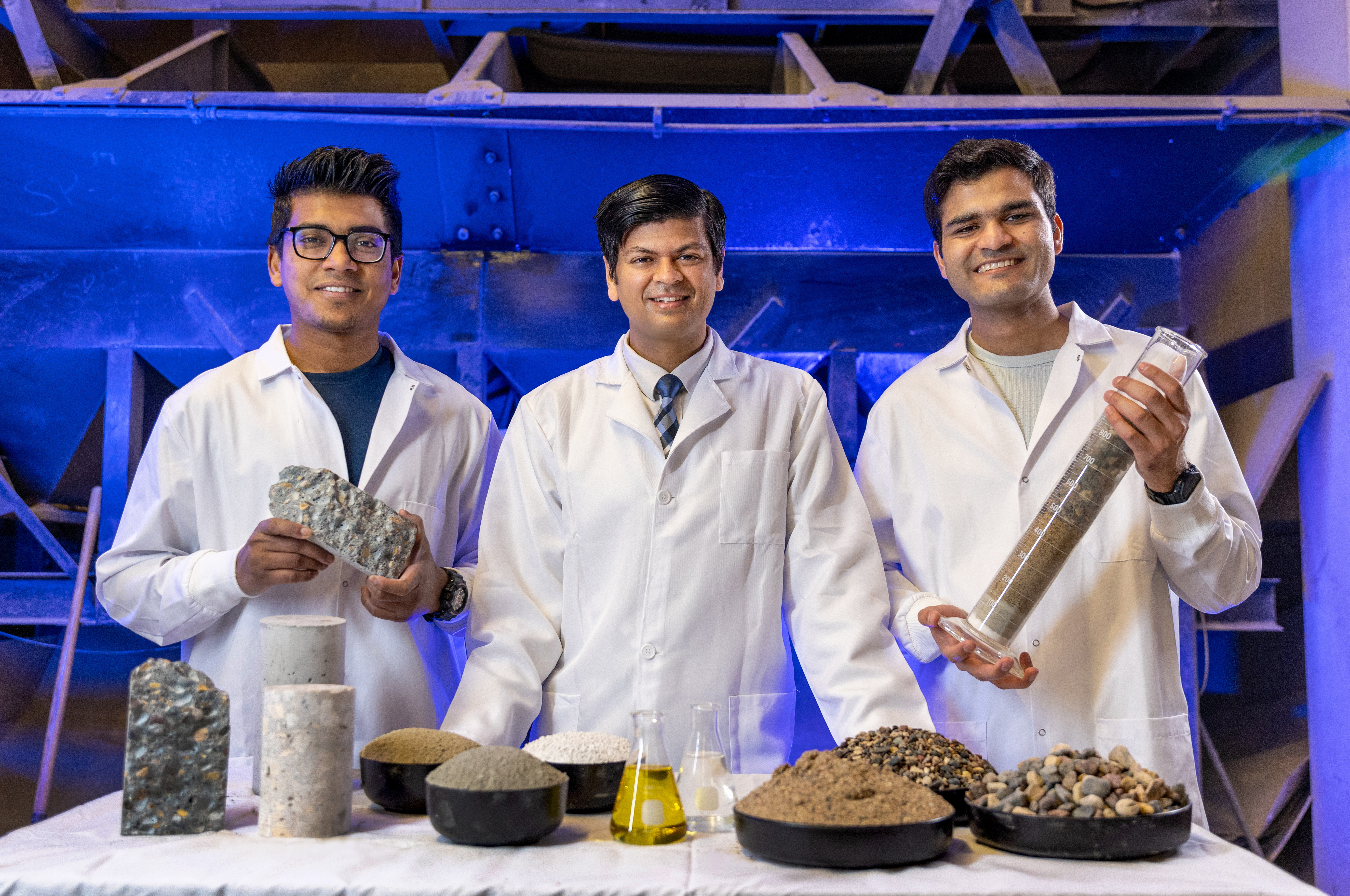 Nishant Garg, center, associate professor with the Department of Civil and Environmental Engineering, joins Bayezid Baten, left, graduate research assistant (CEE) and Ayyan Iqbal, graduate teaching assistant (CEE) at Newmark Lab.