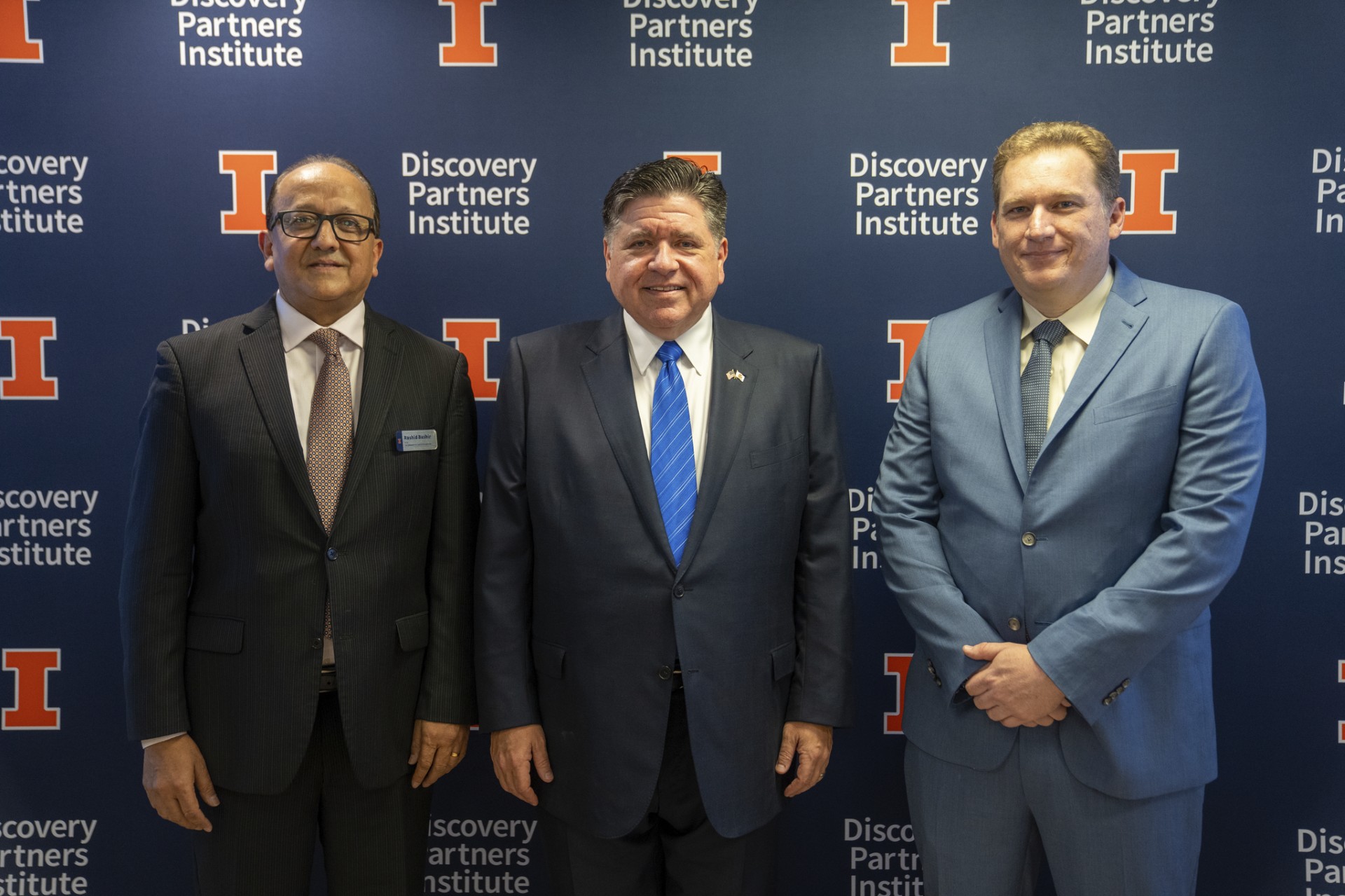 Dean of The Grainger College of Engineering and Vice Chancellor of Chicago Strategic Partnerships Rashid Bashir (left), Illinois Governor JB Pritzker (middle), and Director of IBM Research and IBM Fellow Jay Gambetta (right) celebrate the expansion of the IBM-Illinois Discovery Accelerator Institute.