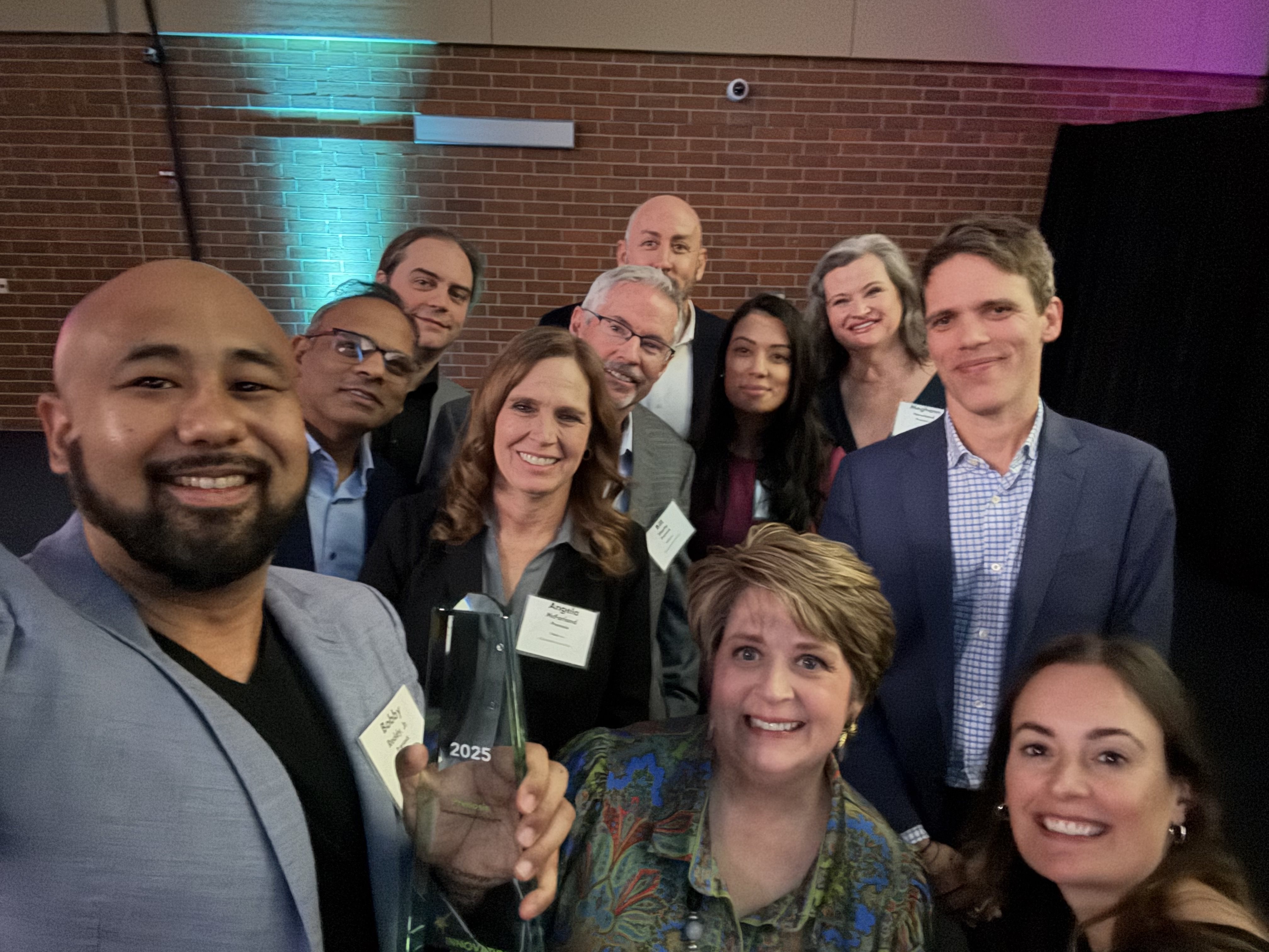 Group photo with Bobby Reddy holding the 2025 award