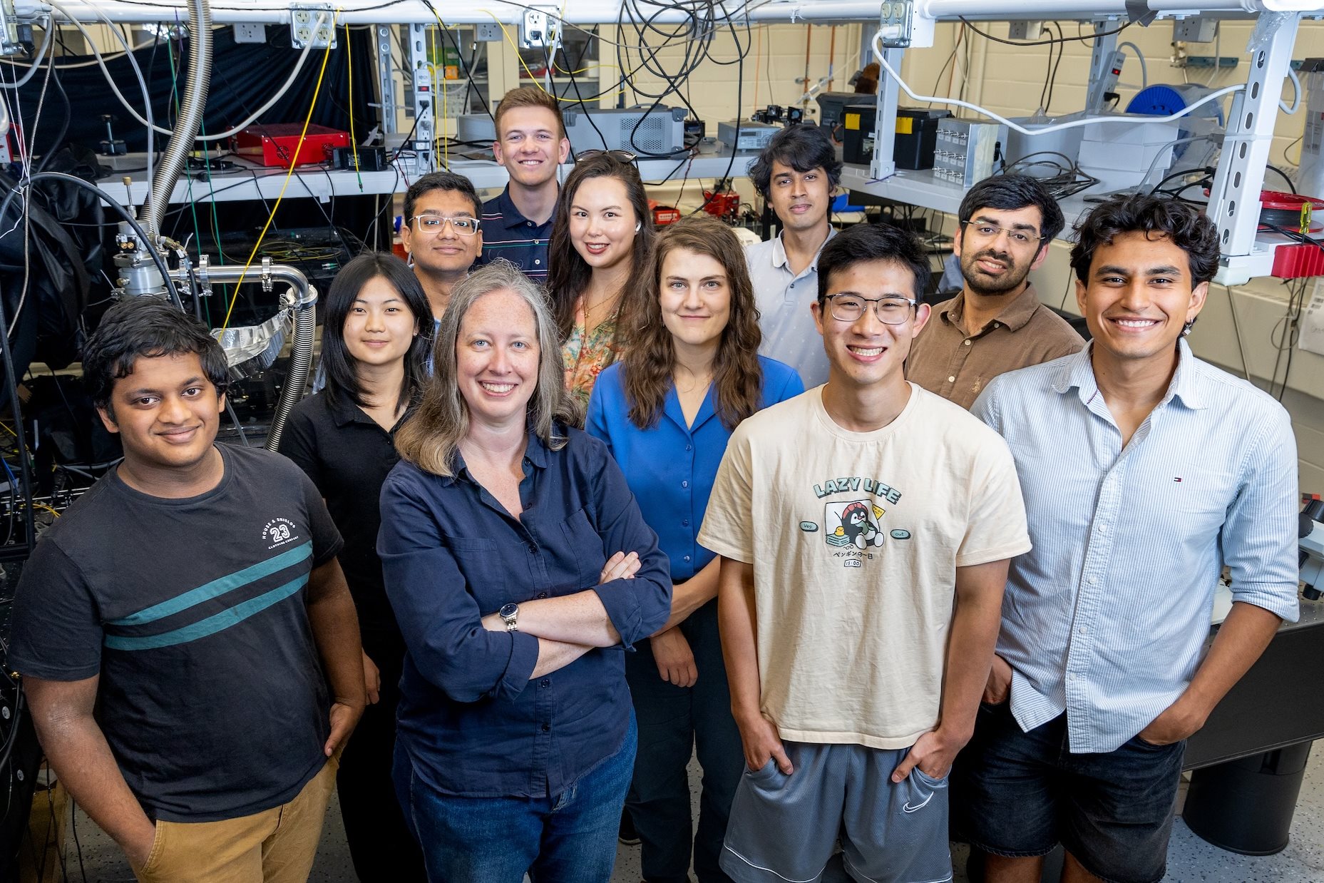 Physics professor Elizabeth Goldschmidt, an experimentalist in quantum optics and quantum information, with members of her research group at the Materials Research Lab.