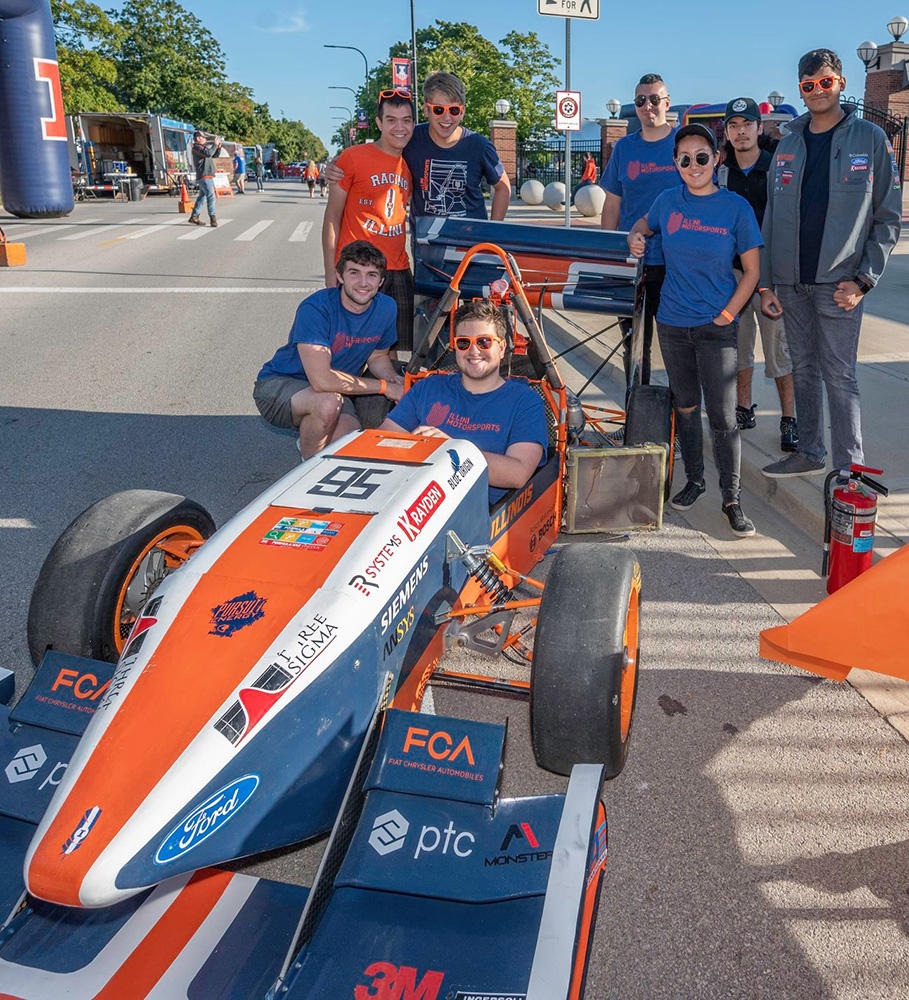 Students riding in hand-made kart