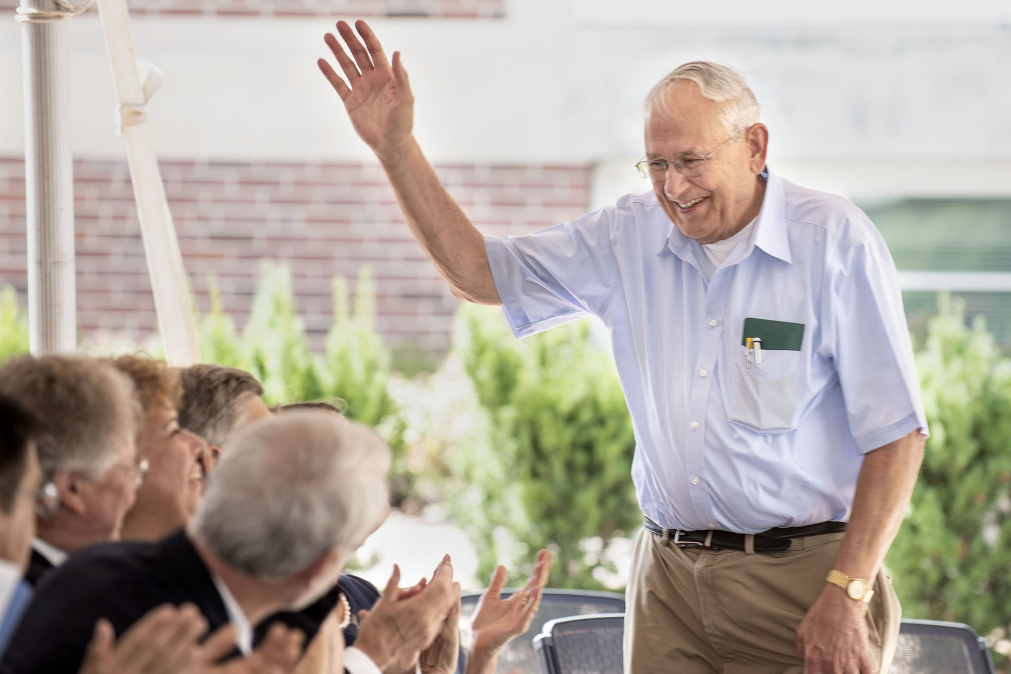 Man waving to crowd