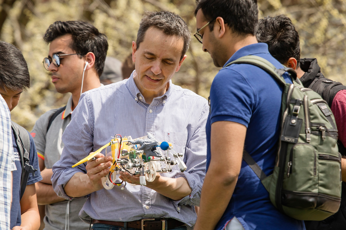 Student and professor interacting with scientific model