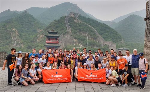 Group of Hoeft T&M students pose with College Engineering and Gies College of Business Banners in China