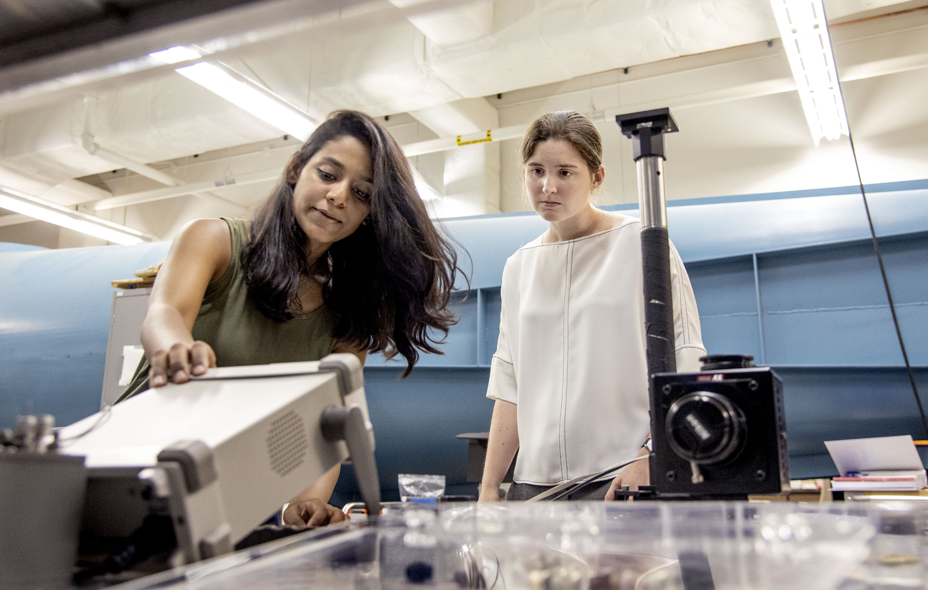 Theresa Saxton-Fox, right, assistant professor in Aerospace, works with Aadhy Sundarajan, a graduate student, at a wind tunnel where they measure turbulent layer, the temporal control field, and the dynamic pressure gradients at Engineering Student Project Laboratory on July 18, 2019. The research group focuses on the behavior of air as it flows past surfaces.