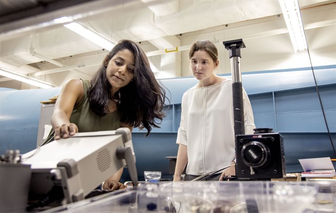 Theresa Saxton-Fox, right, assistant professor in Aerospace, works with Aadhy Sundarajan, a graduate student, at a wind tunnel where they measure turbulent layer, the temporal control field, and the dynamic pressure gradients at Engineering Student Project Laboratory on July 18, 2019. The research group focuses on the behavior of air as it flows past surfaces. &nbsp;<em>Photo by Heather Coit</em>