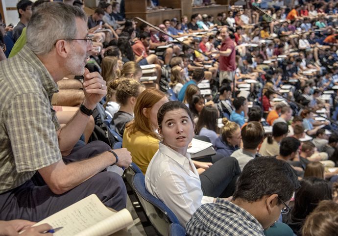 Theresa Saxton-Fox, center, an Aerospace professor, and Chris Migotsky, upper left, coordinator of faculty teaching programs for AE3, observe Tim Stelzer, Physics professor, seen engaging his students in the background, during an "excellent teacher visit" as part of the Collins Scholars program. Saxton-Fox, one of 35 Collins Scholars currently enrolled, will "graduate" from the program in Spring 2020. <em>Photo by Heather Coit</em>