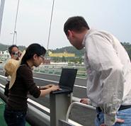 Illinois team members Shinae Jang and Kirill Mechitov check out the sensors via laptop computer.