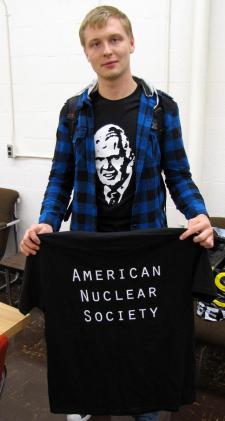 Cody Morrow, treasurer for the American Nuclear Society student chapter at iIllinois, shows off the organizations latest fashion apparel honoring NPRE Prof. Roy Axford.