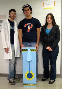 (l to r) Ian Bradley, graduate researcher, with Peter Maraccini and Kimberly Parker, undergraduate project leads. They are standing behind a concrete biosand filter painted with Mayan designs to appeal to users. It can produce about 20 liters of clean water every use.