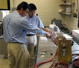 NPRE Assistant Prof. Ling Jian Meng (r) explains some of his latest research projects to alumnus Michael Kaminski (BS 1994, MS 1996, PhD 1998, Nuclear Engineering), now a scientist at Argonne National Laboratory.