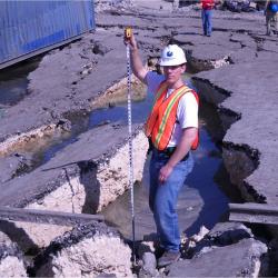 Measuring the depth of the cracks near the wharf.