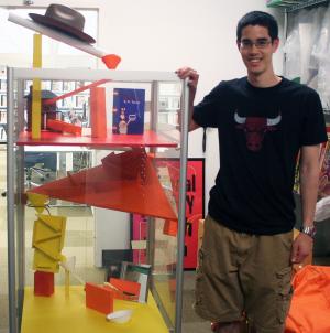 Illinois Rube Goldberg Team president Doug Tanaka shows off the marble maze at the Champaign Public Library.