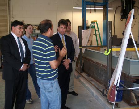 ATREL Director Imad Al Qadi (l) and RITA Administrator Peter Appel (ctr.) are briefed by a graduate student about his high-speed rail-related project.