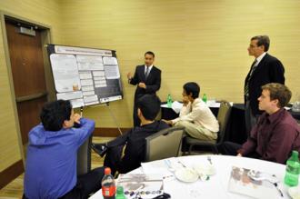 Students present their research[cr][lf]at a poster session.