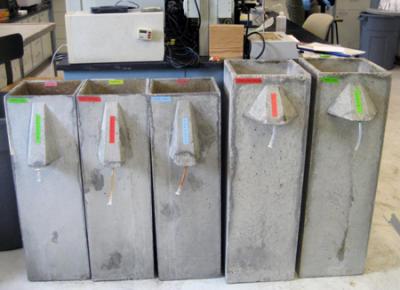 Biosand filters (l-r): Three separate Version 9 filters using traditional sand media, sand mixed with iron particles, and sand mixed with steel wool to study long term (&amp;gt;185 days) virus removal. Newly released Version 10 filters (sand only, amended with steel wool), which have a larger cross-sectional area and longer sand column height for increased removal.