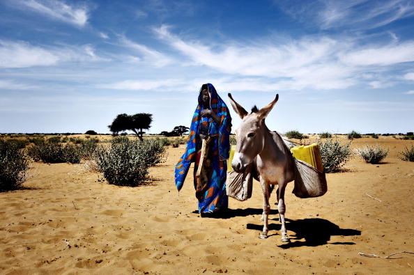 A women from a village on her way to collect well water.