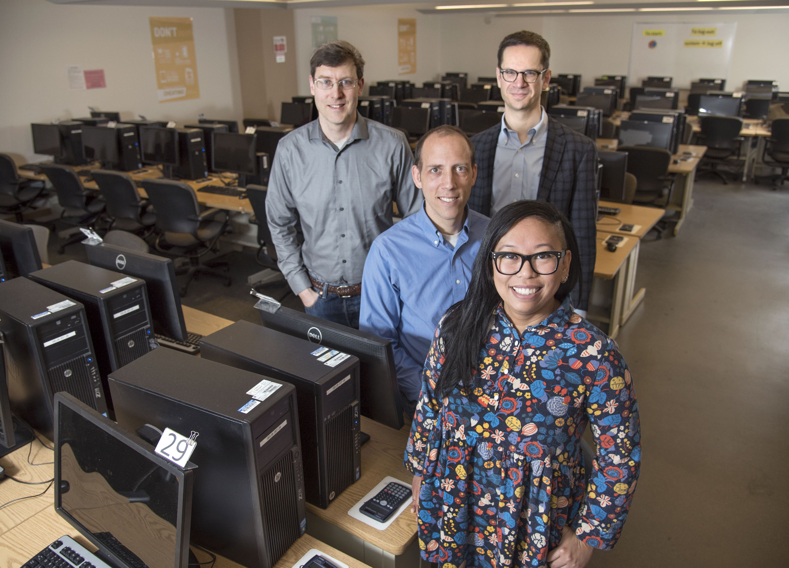 Prairie Learn SIIP project team members (l-r) Craig Zilles (computer science), Tim Bretl (aerospace engineering) and Matthew West (mechanical science and engineering) join Carleen Sacris (front), coordinator of the Computer-Based Testing Facility, at the CBTF lab.