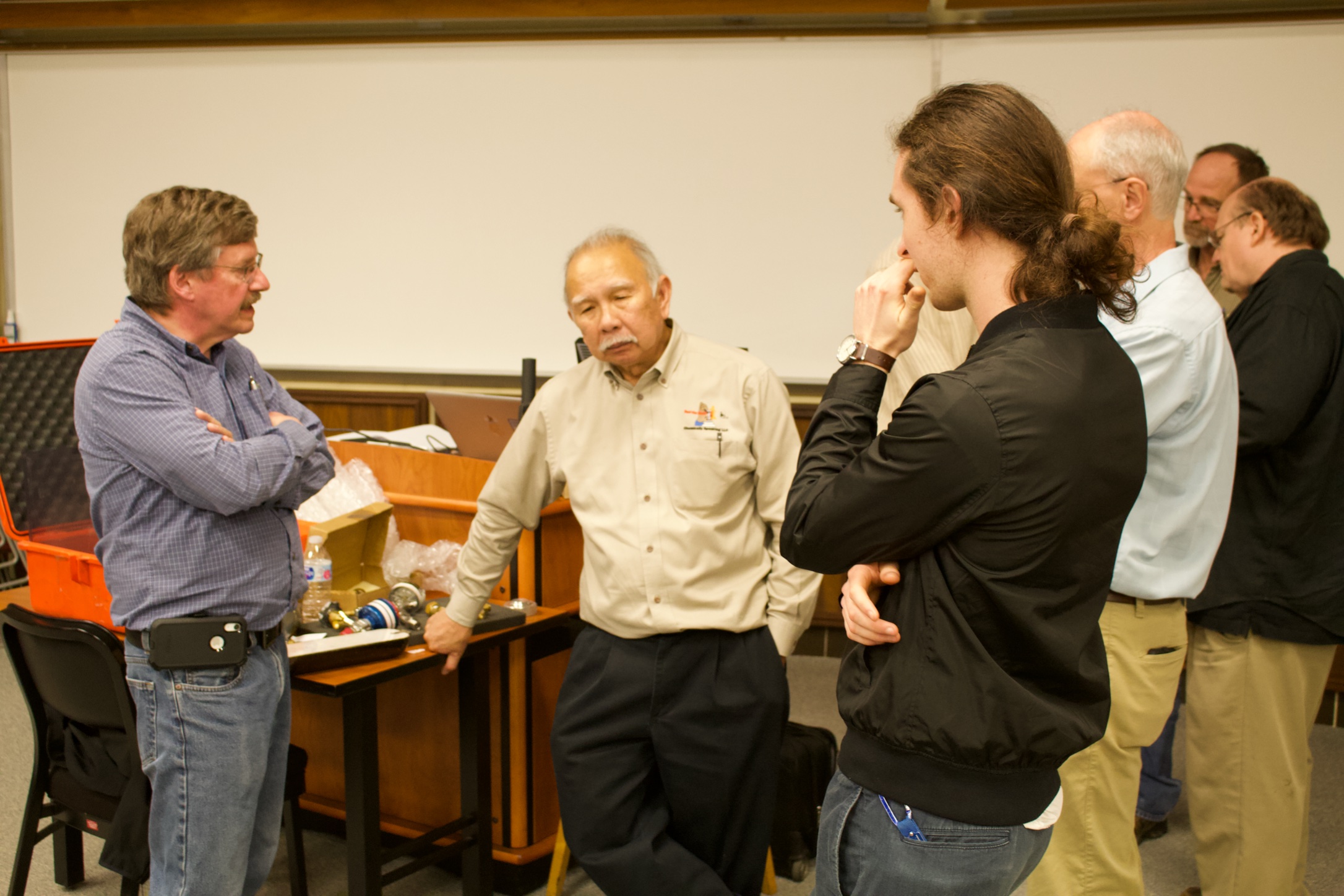 Mark McCollum, MNTL cleanroom principal research engineer, poses a question to Eugene Ngai.