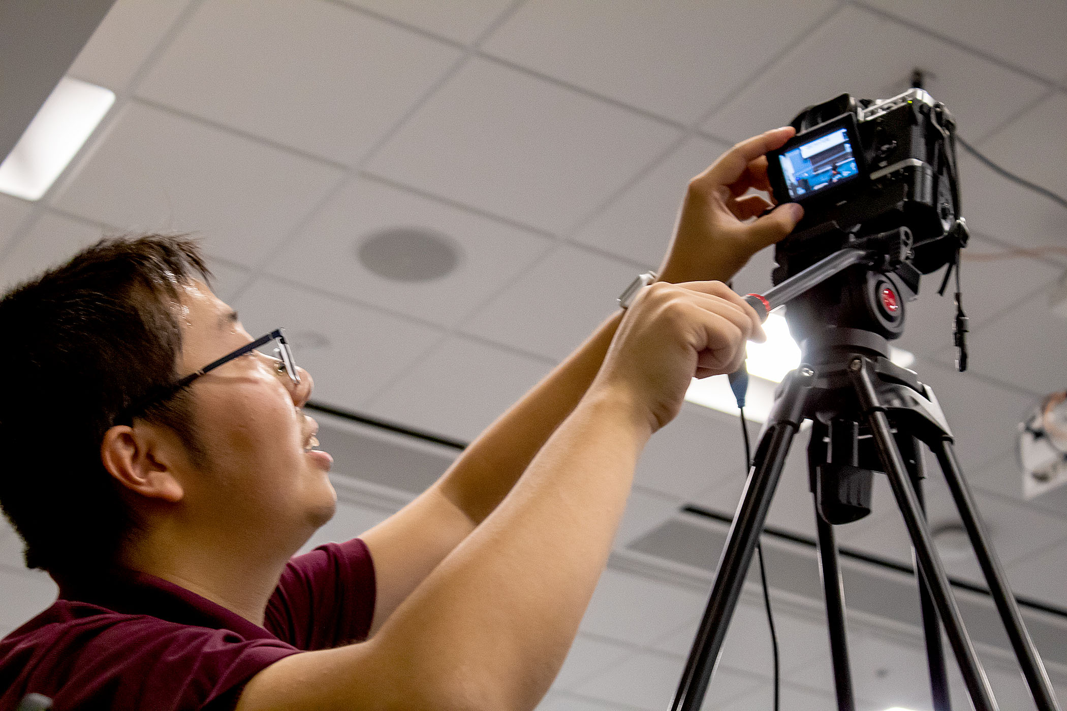 Jimmy He, a founding member of WaggleNet, sets up a camera to live stream the team's tri-weekly colloquium series.