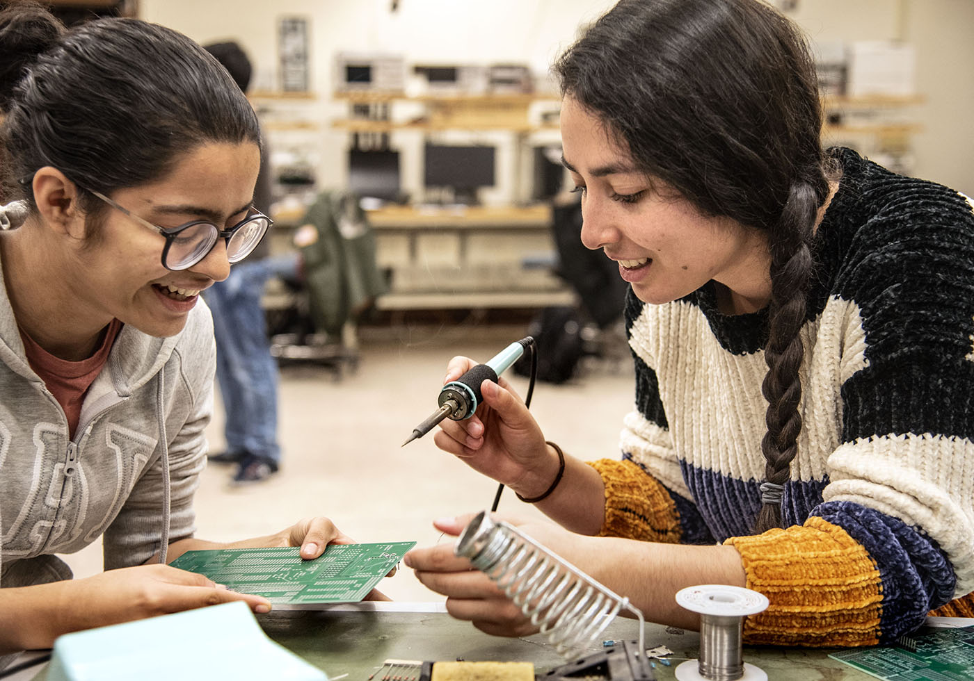 Two students work in lab