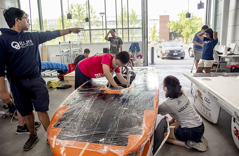 Members of the Illini Solar Car team work on their car Brizo
