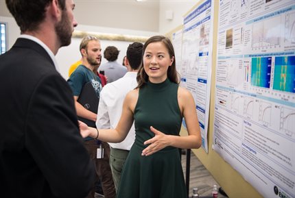 Amanda Loutris speaking in front of an academic poster