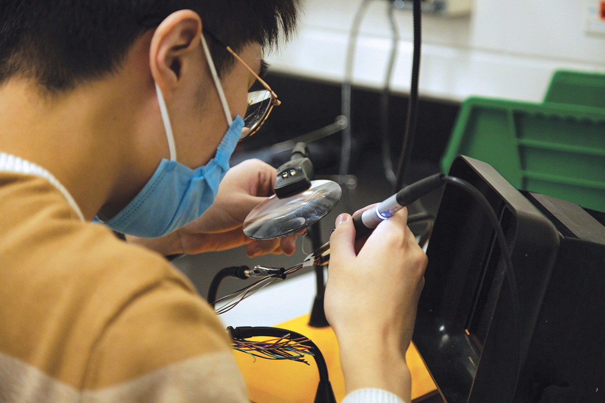 Student using soldering iron