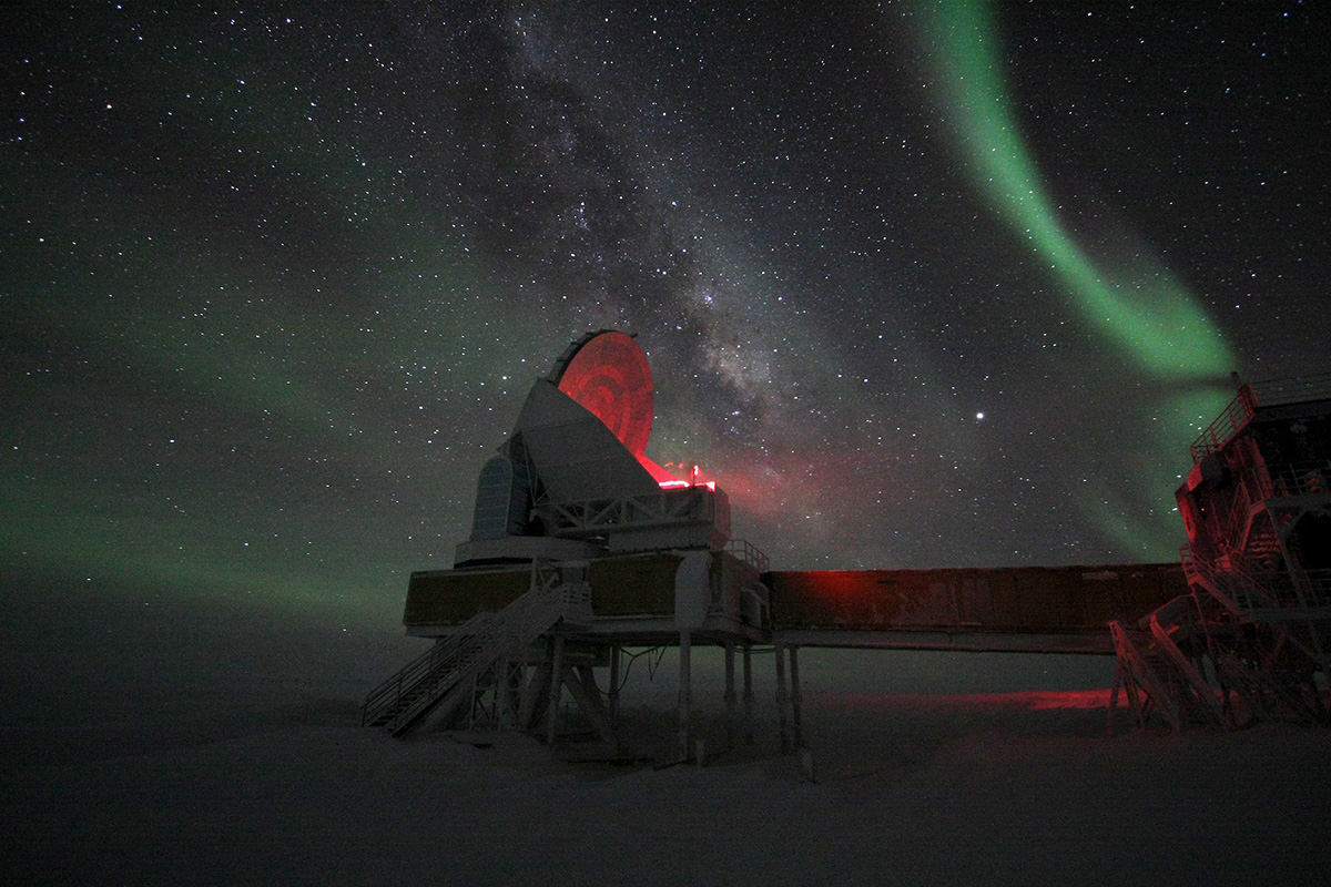 telescope with a starry ski and aurora borealis in the background