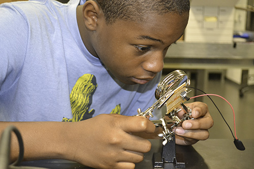 image of young male learning about mechanics
