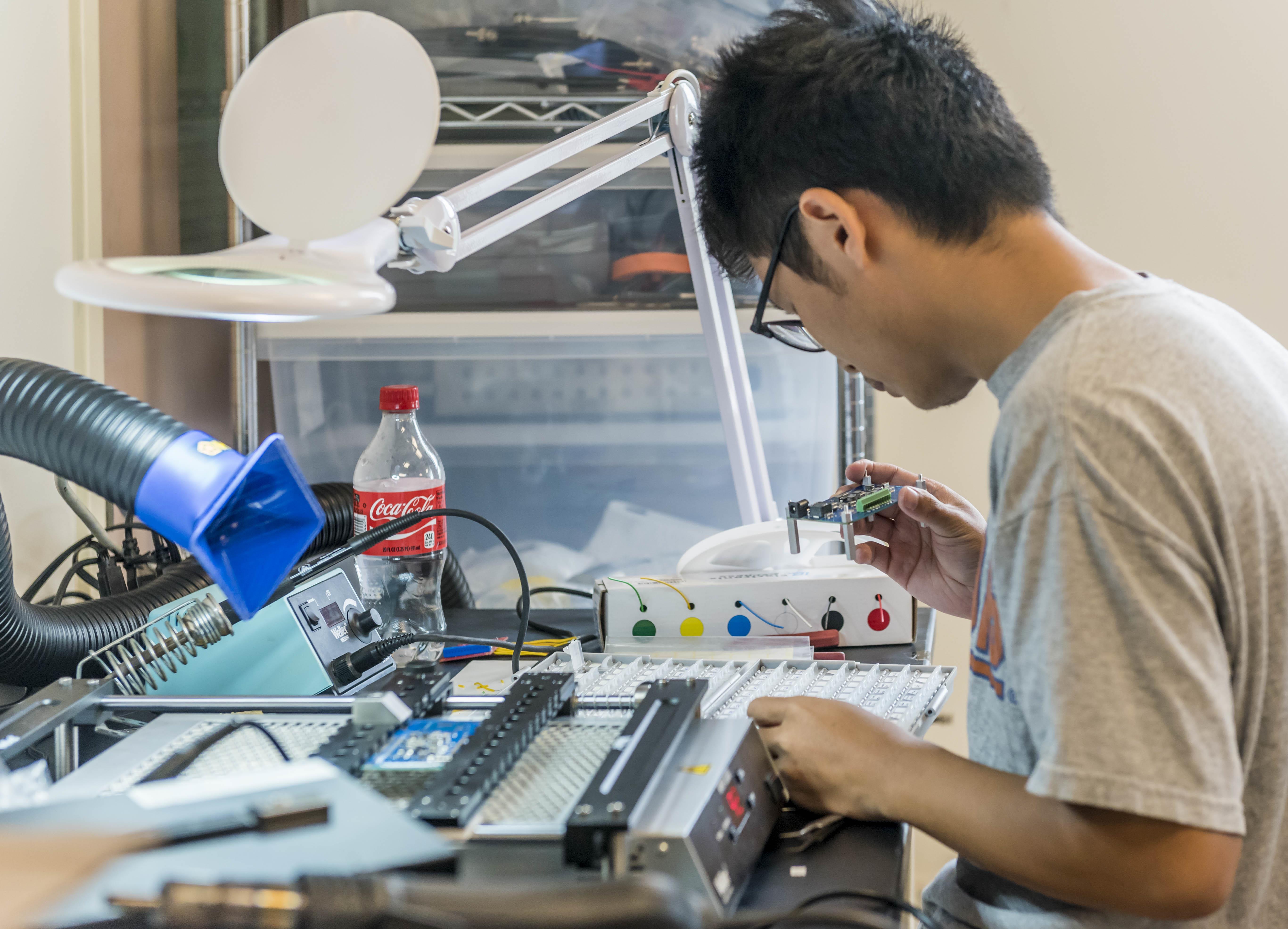 young man working on circuit board