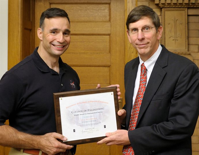 Archambault receiving the Alumni Award for Distinguished Service from former Dean Michael Bragg.