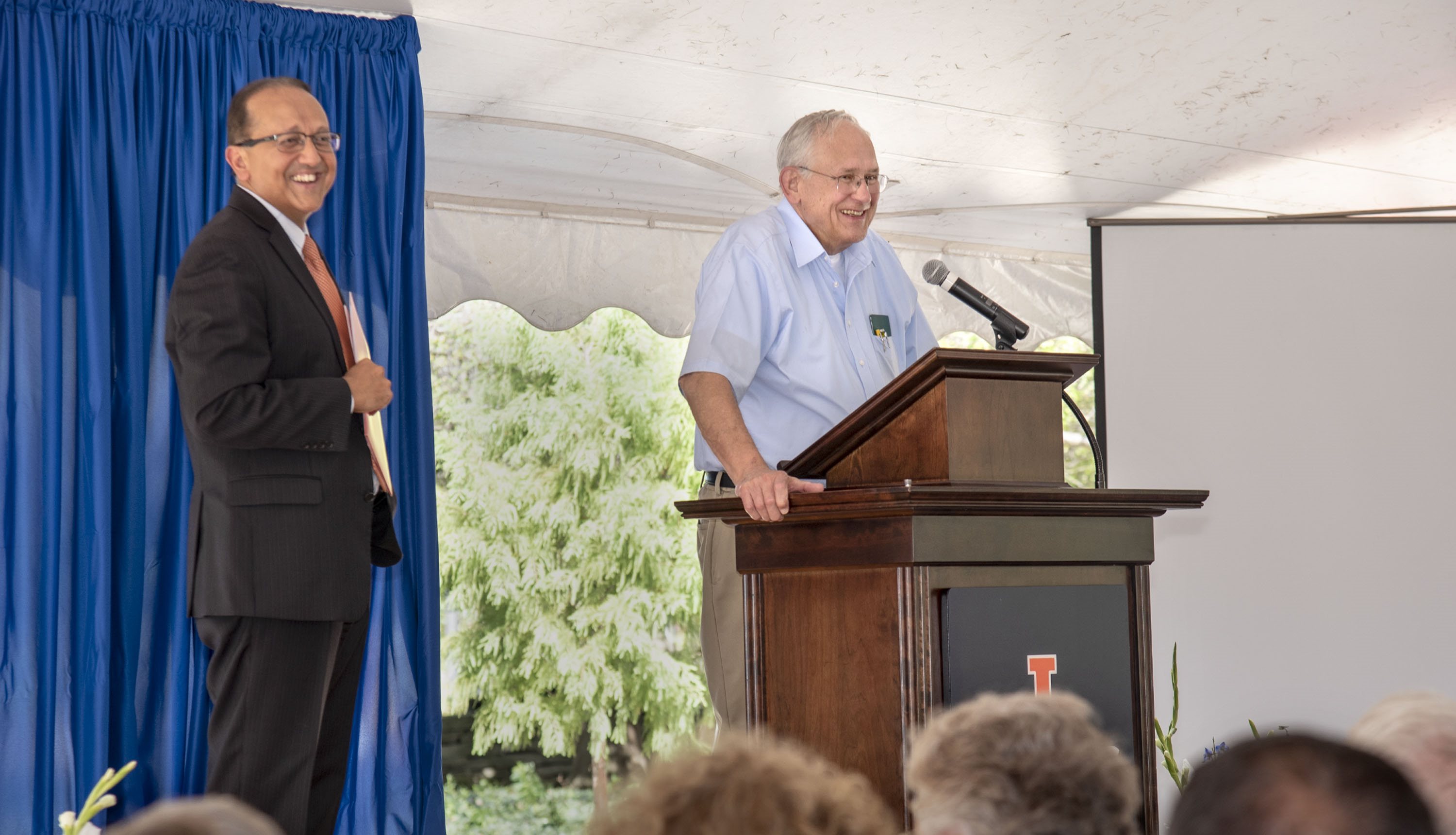 Dean Rashid Bashir and Prof. Pete Sauer presenting awards at a faculty meeting