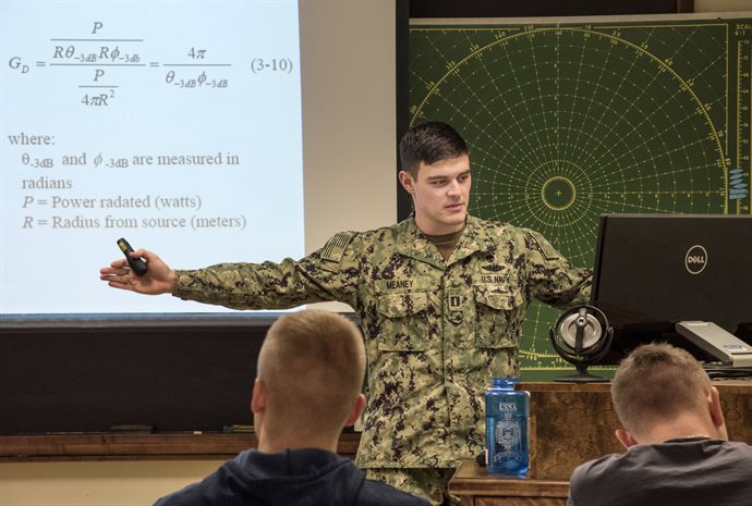 Lt. Daniel Meaney, USN, assistant professor in Naval Science, teaches his Naval Weapon Systems (NS 306) class at the UI Armory during spring semester. The class provides students with the principles of weapons deployment, both offensive and defensive; as well as teaching the theory behind challenges presented to the warfighter, using physics, chemistry, electronics, and cyber. <em>Photo by Heather Coit</em>