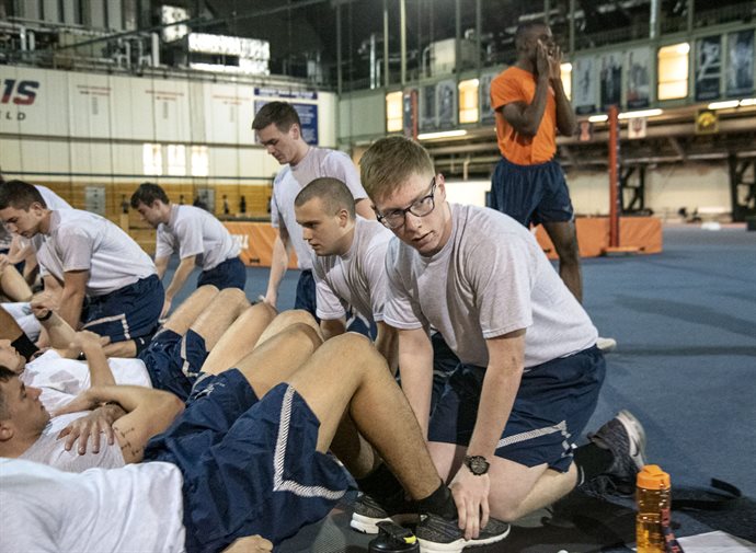 Ryan Nixon, who recently finished his freshman year enrolled in Mechanical Science and Engineering, pairs up with a fellow Air Force ROTC cadet for early morning physical training (PT) at the UI Armory earlier during spring semester. <em>Photo by Heather Coit</em>