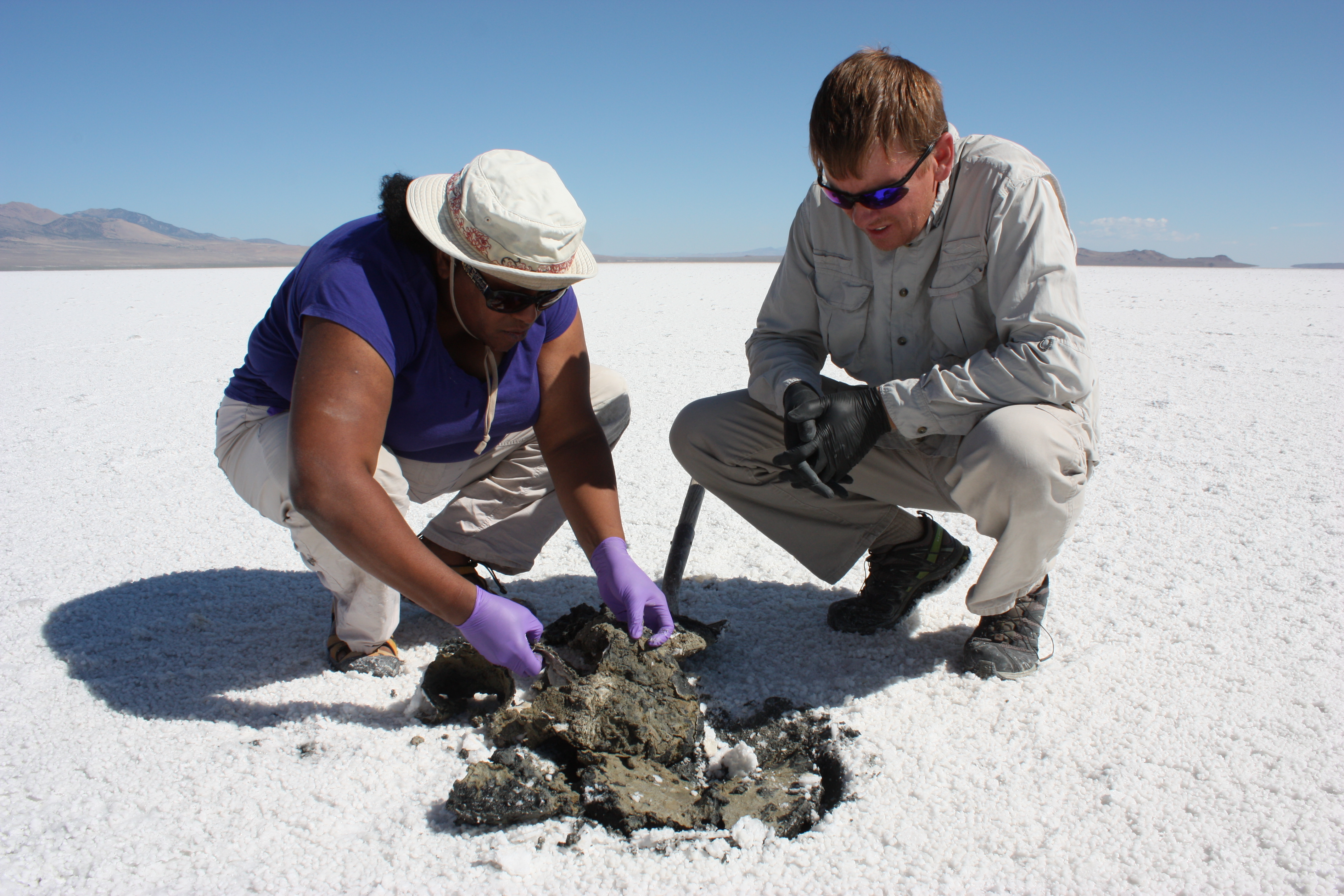 Kennda and colleague inspecting soil materials