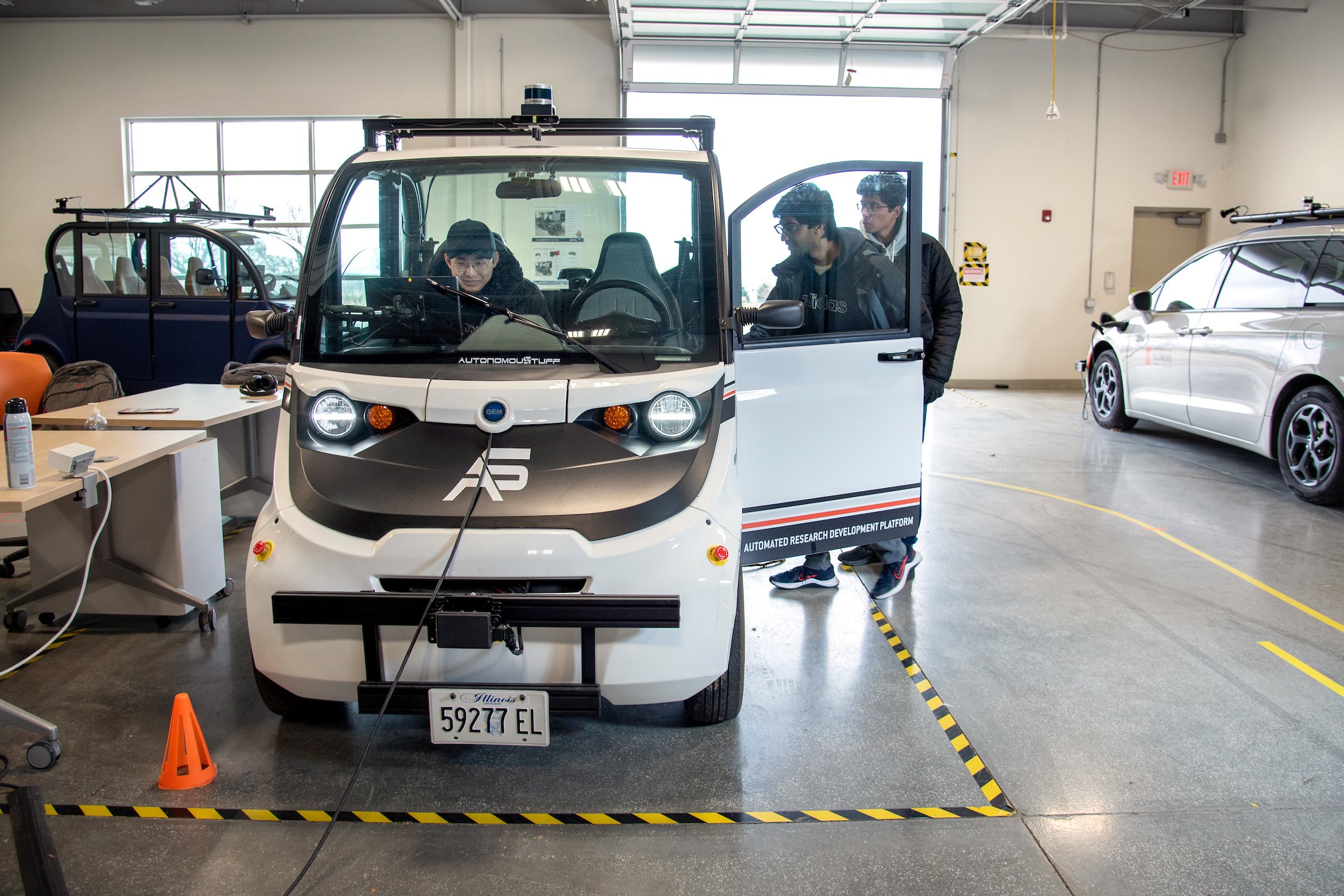 Electrical and Computer Engineering graduate teaching assistant, John Pohovey, oversees an ECE 484 - Principles of Safe Autonomy class at the The Highbay Testbed facility in Champaign Dec. 2023.