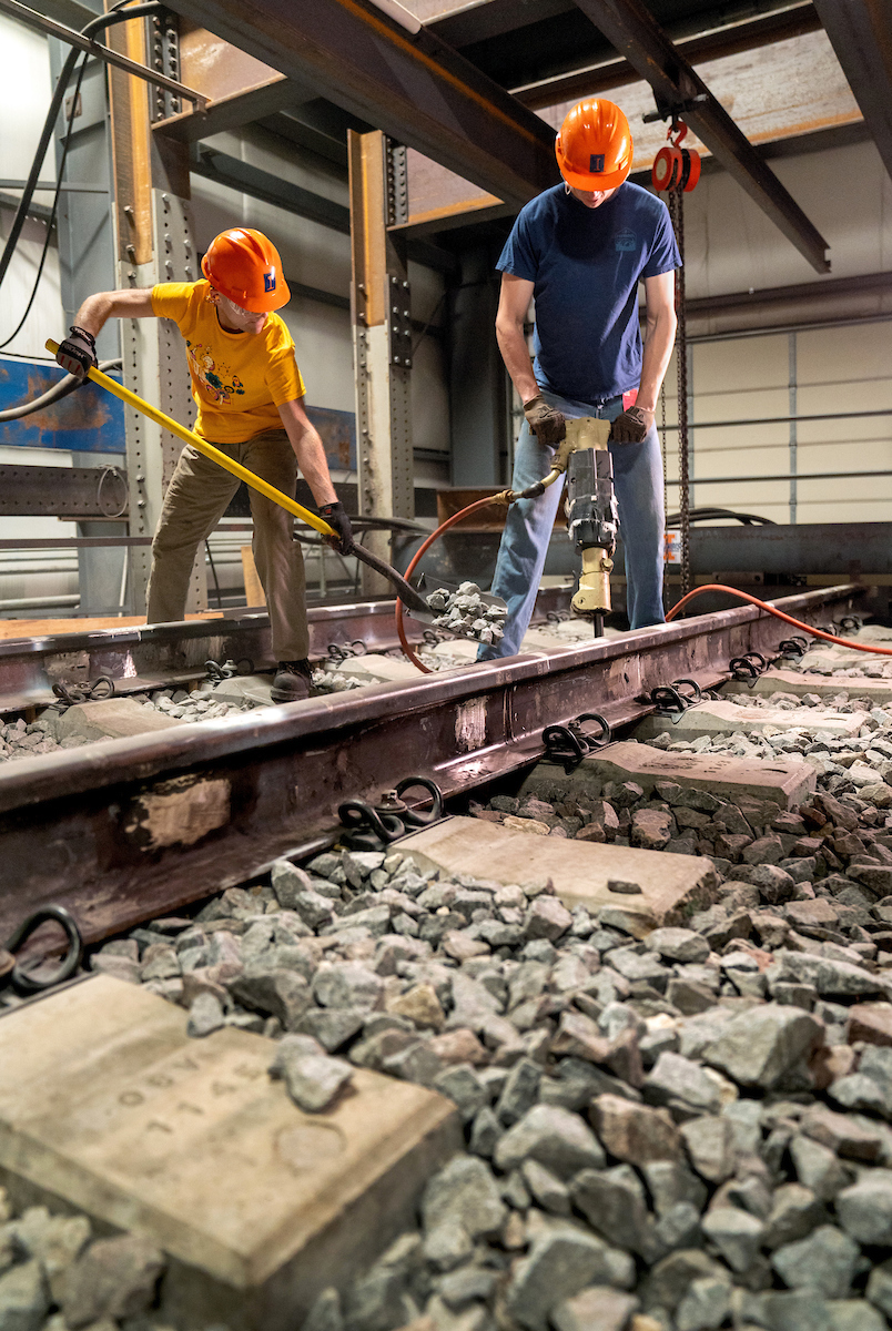 RailTEC's graduate research assistants, L-R, David Wasilewski and  Coleman Froehlke, get hands-on training on the Track Loading System (TLS) at the Research and Innovation Laboratory (RAIL) in Champaign.