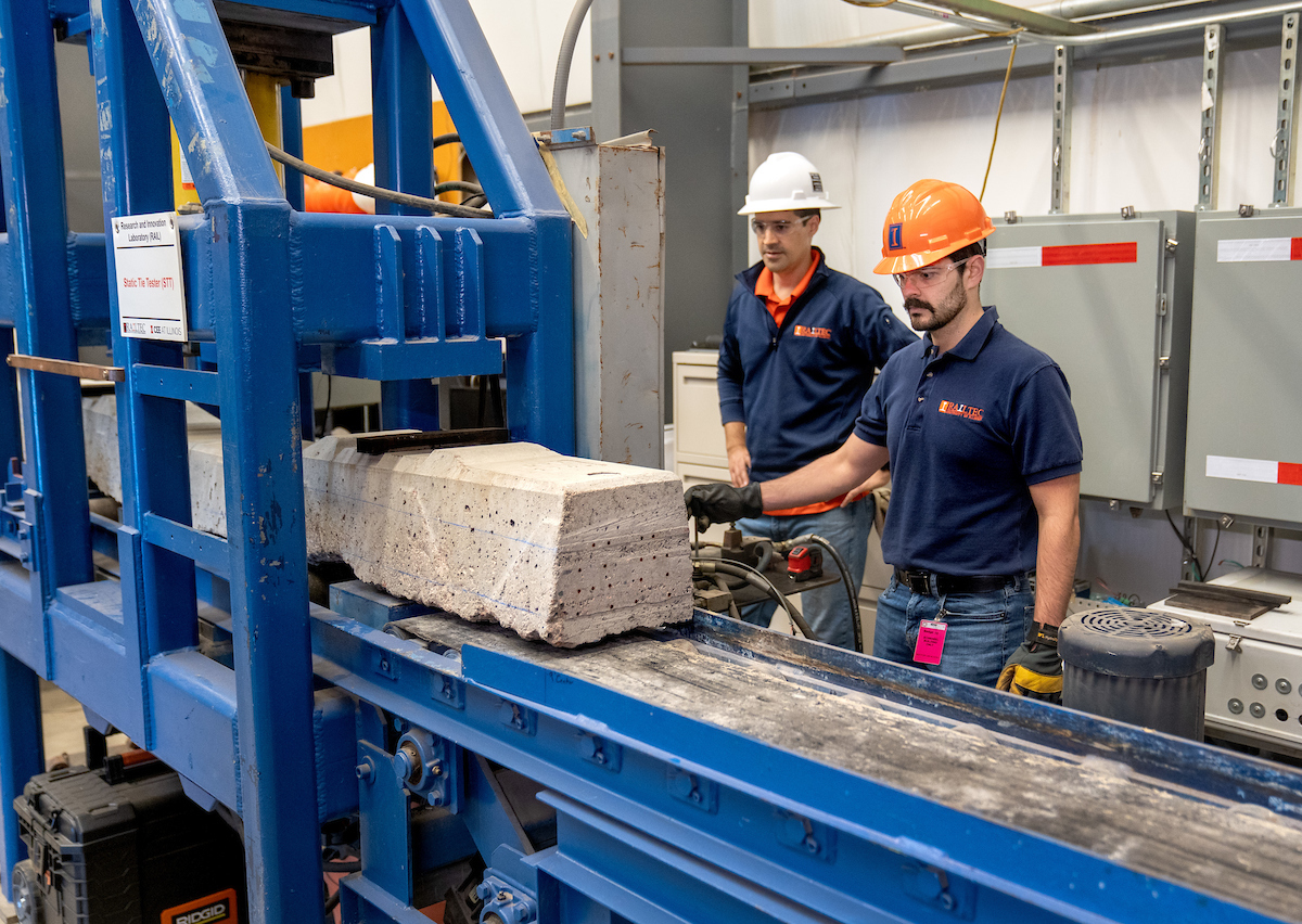 RailTEC's Arthur de Oliveira Lima, research engineer, left, and Vitor Alves, graduate research assistant, at the Static Tie Tester (STT) platform  at the Research and Innovation Laboratory (RAIL) in Champaign.